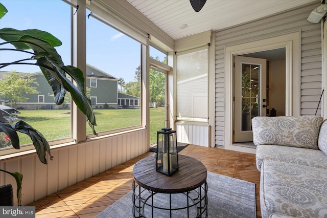 sunroom / solarium featuring a ceiling fan