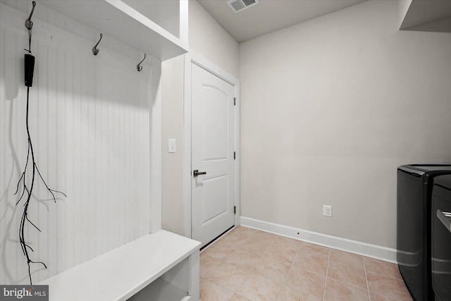 mudroom featuring separate washer and dryer and baseboards