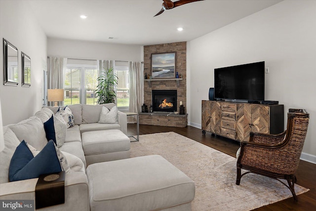 living room with a ceiling fan, a fireplace, wood finished floors, recessed lighting, and baseboards