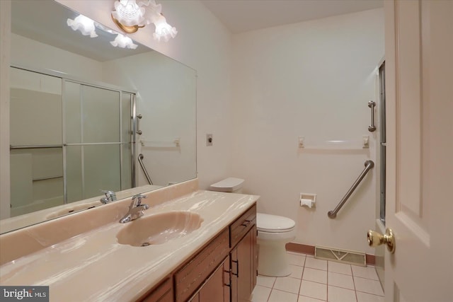 1300 Sand Hill Rd, Hummelstown, PA 17036 - bathroom featuring vanity, tile patterned floors, toilet, visible vents, and a shower with shower door