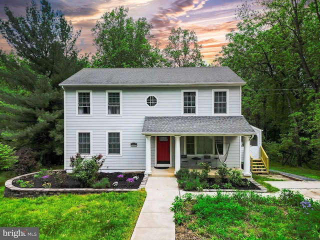 view of front of house featuring a porch and roof with shingles