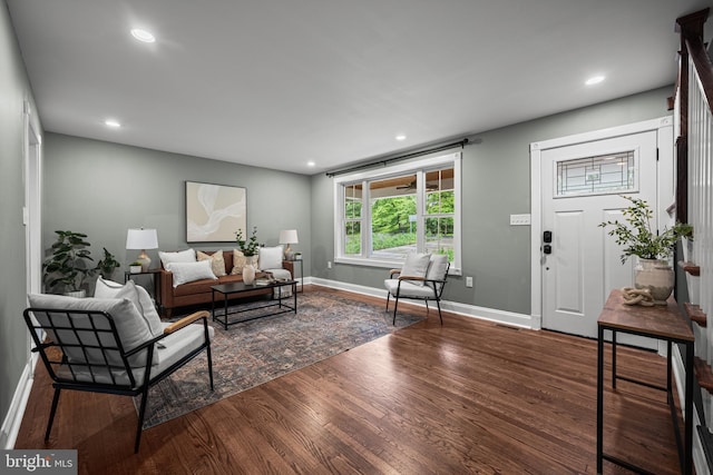 living area featuring wood finished floors, baseboards, and recessed lighting