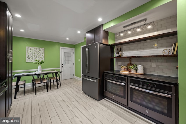 kitchen featuring stainless steel appliances, light wood-style floors, baseboards, recessed lighting, and tasteful backsplash