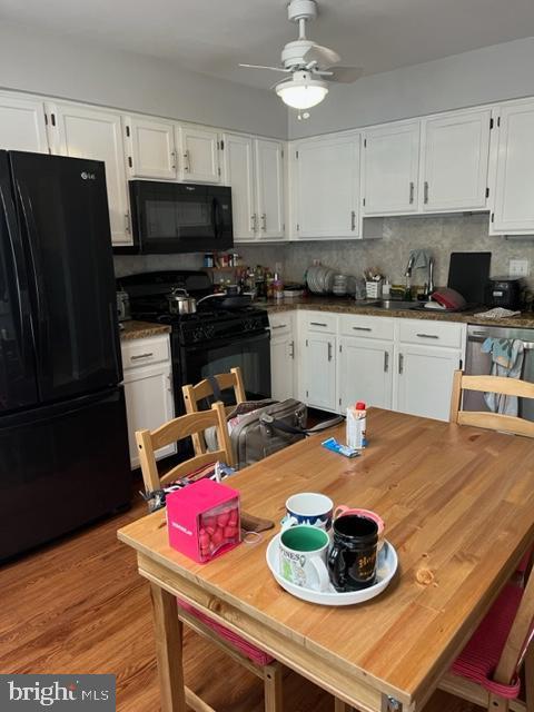 302 Weston Ln Unit 23, New Hope, PA 18938 - kitchen featuring black appliances, a sink, white cabinetry, a ceiling fan, and tasteful backsplash