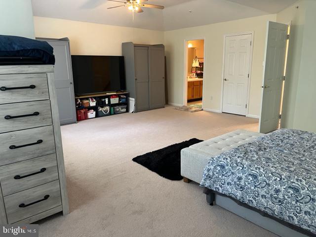 302 Weston Ln Unit 23, New Hope, PA 18938 - bedroom with light carpet, ensuite bath, and a ceiling fan