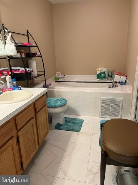 302 Weston Ln Unit 23, New Hope, PA 18938 - full bathroom with toilet, a garden tub, vanity, and marble look tiles
