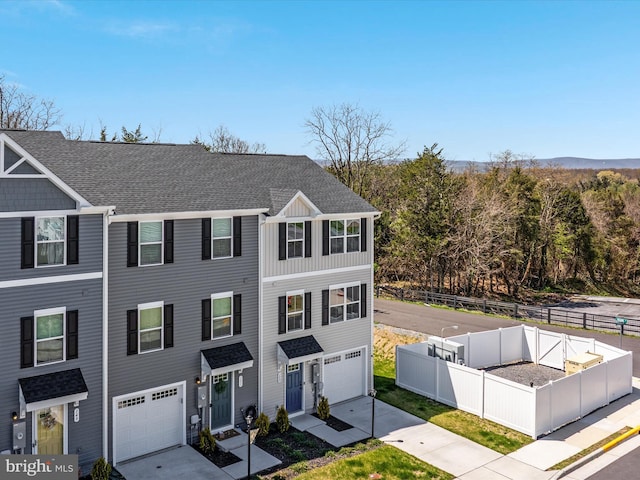 153 Kensington Cir, Middletown, VA 22645 - view of front of home with an attached garage, a shingled roof, fence, and concrete driveway