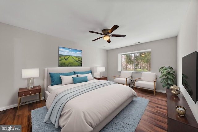 bedroom featuring wood finished floors, visible vents, a ceiling fan, and baseboards
