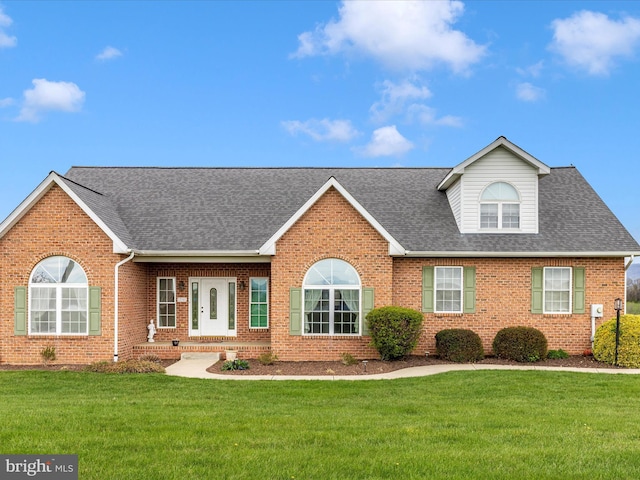 ranch-style house featuring brick siding, roof with shingles, and a front lawn