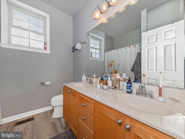 bathroom featuring baseboards, visible vents, a sink, and toilet