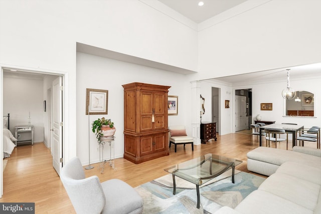 29 Sparrow Dr, Hamilton, NJ 08690 - living room with a notable chandelier, a high ceiling, ornamental molding, light wood-style floors, and recessed lighting