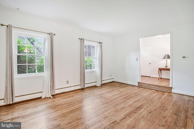 8205 Robin Hood Ct, Towson, MD 21204 - spare room featuring light wood finished floors, plenty of natural light, and baseboards