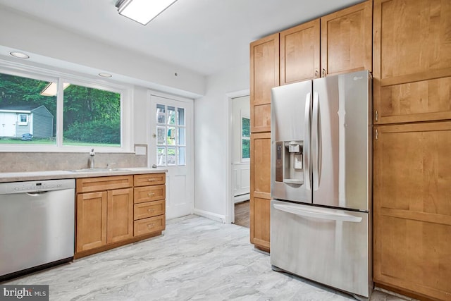 8205 Robin Hood Ct, Towson, MD 21204 - kitchen featuring appliances with stainless steel finishes, a sink, light countertops, baseboards, and brown cabinets