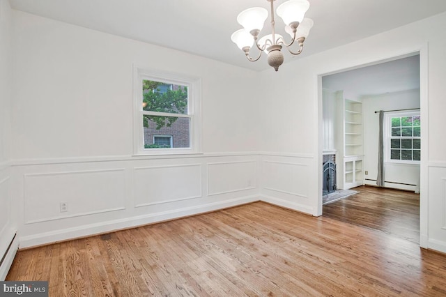 8205 Robin Hood Ct, Towson, MD 21204 - unfurnished room featuring a chandelier, a baseboard heating unit, wood finished floors, wainscoting, and built in shelves