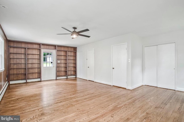 8205 Robin Hood Ct, Towson, MD 21204 - unfurnished living room with light wood-style floors, a ceiling fan, built in features, baseboards, and a baseboard heating unit