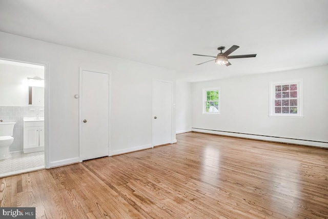 8205 Robin Hood Ct, Towson, MD 21204 - unfurnished bedroom with wood finished floors, connected bathroom, a baseboard heating unit, and a ceiling fan