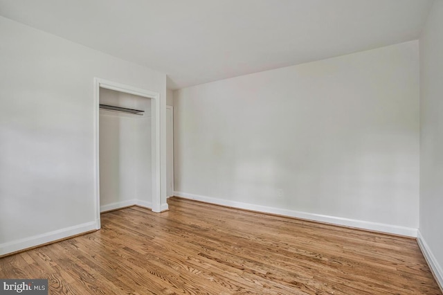 8205 Robin Hood Ct, Towson, MD 21204 - unfurnished bedroom featuring wood finished floors, baseboards, and a closet