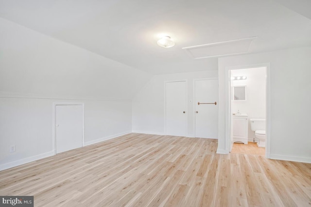8205 Robin Hood Ct, Towson, MD 21204 - additional living space with light wood-style flooring, vaulted ceiling, and attic access