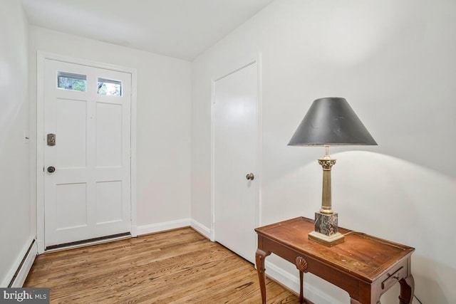 8205 Robin Hood Ct, Towson, MD 21204 - entryway featuring a baseboard heating unit, light wood finished floors, and baseboards