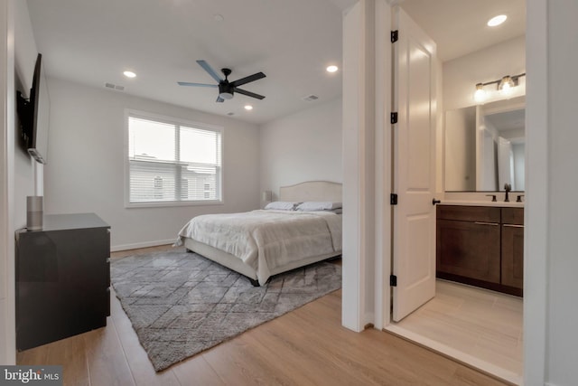 bedroom with recessed lighting, light wood finished floors, visible vents, and connected bathroom
