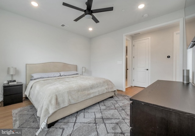 bedroom with light wood finished floors, ceiling fan, visible vents, and recessed lighting