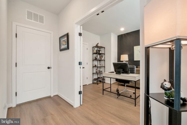 office space with light wood-style floors, recessed lighting, visible vents, and baseboards