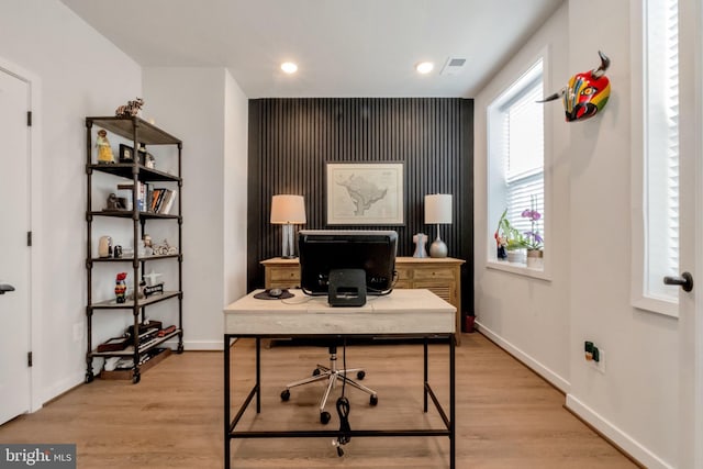 office featuring light wood-type flooring, baseboards, visible vents, and recessed lighting