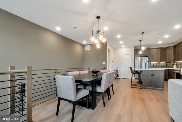 dining area featuring light wood-style floors, recessed lighting, and visible vents