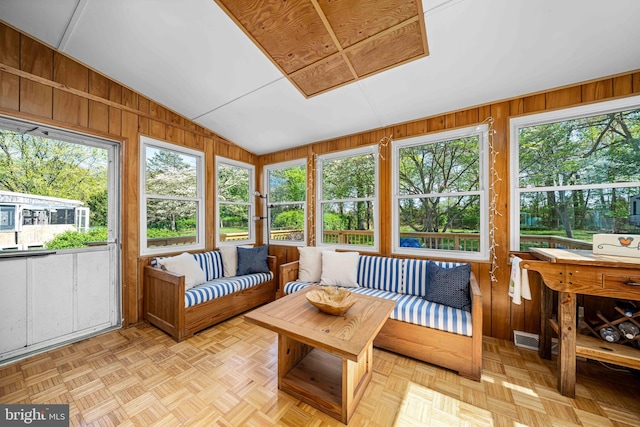sunroom / solarium with a healthy amount of sunlight, an outdoor living space, and visible vents