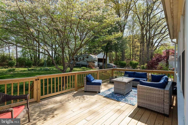 wooden terrace with an outdoor living space