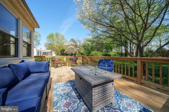wooden deck with an outdoor living space