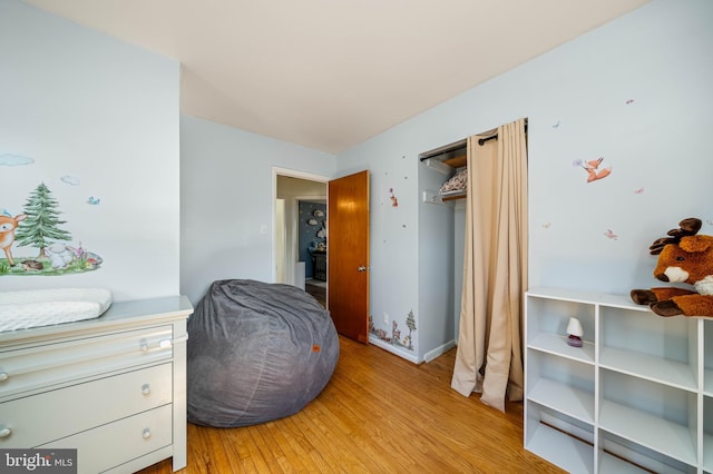 bedroom featuring light wood-style floors and baseboards