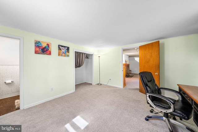 unfurnished office featuring carpet floors and baseboards