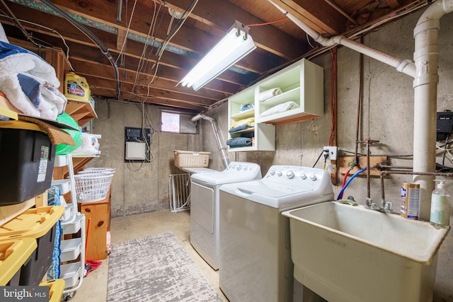 laundry area featuring a sink, laundry area, and washer and dryer
