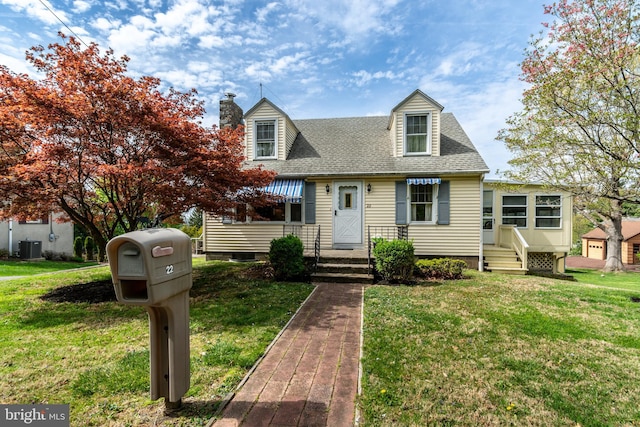 cape cod house with a shingled roof, a front lawn, central air condition unit, and a chimney