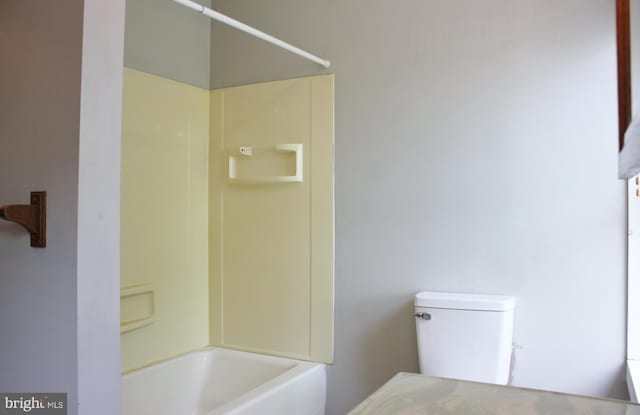 bathroom with toilet and  shower combination