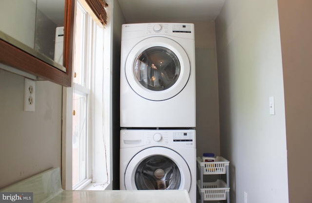 washroom featuring stacked washer / dryer