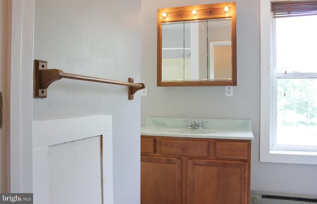 bathroom featuring a baseboard heating unit, healthy amount of natural light, and vanity