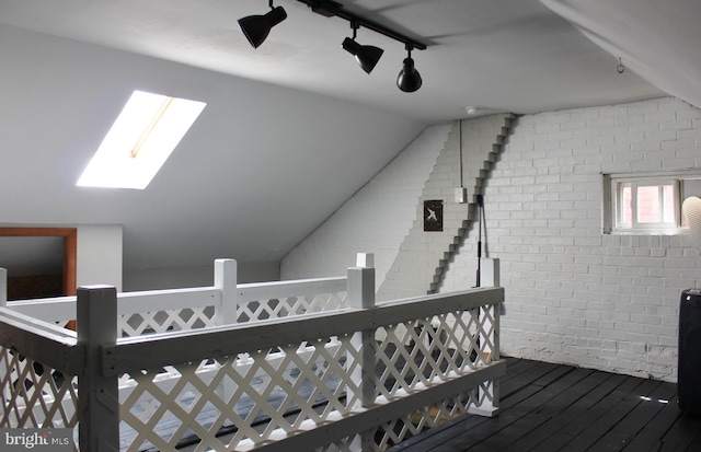 bonus room featuring a skylight, wood finished floors, and vaulted ceiling