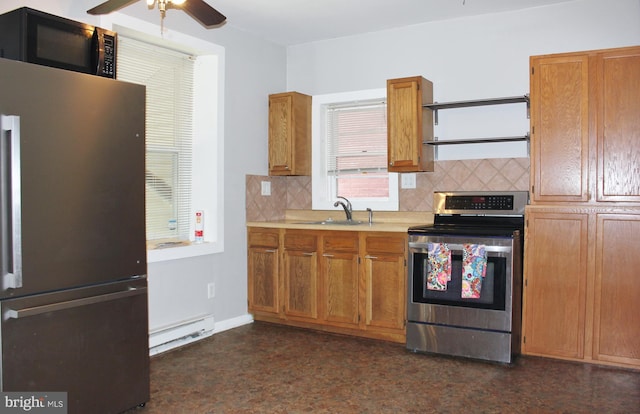 kitchen featuring stainless steel appliances, a baseboard radiator, tasteful backsplash, and a sink