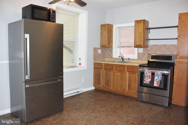 kitchen featuring stainless steel appliances, a baseboard heating unit, tasteful backsplash, and a sink