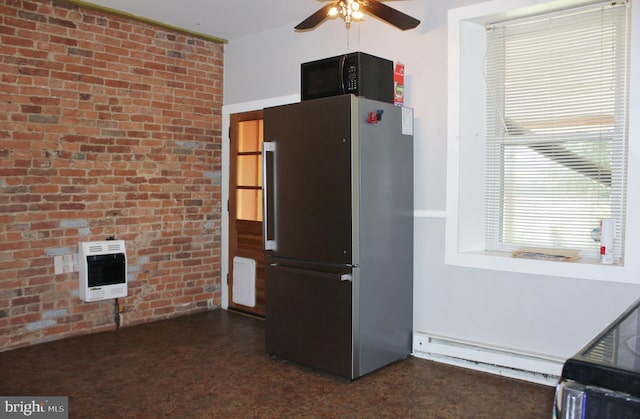 kitchen featuring freestanding refrigerator, heating unit, a baseboard heating unit, black microwave, and a ceiling fan