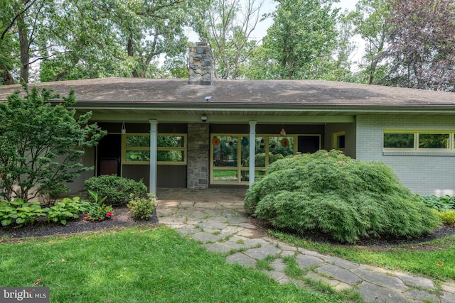142 Woodside Rd, Lancaster, PA 17601 - back of property with a chimney, brick siding, and a shingled roof