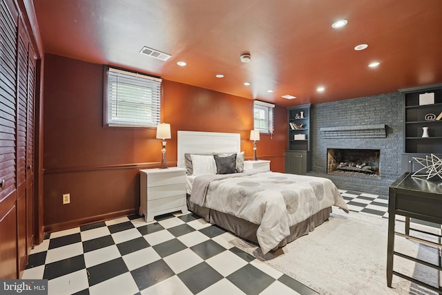7910 Bayberry Dr, Alexandria, VA 22306 - bedroom featuring a brick fireplace, tile patterned floors, recessed lighting, and baseboards