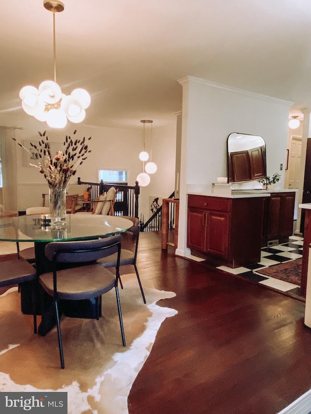 7910 Bayberry Dr, Alexandria, VA 22306 - dining area featuring a chandelier, dark wood-style flooring, and ornamental molding