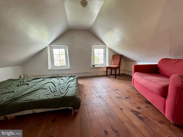 bedroom with wood-type flooring and lofted ceiling