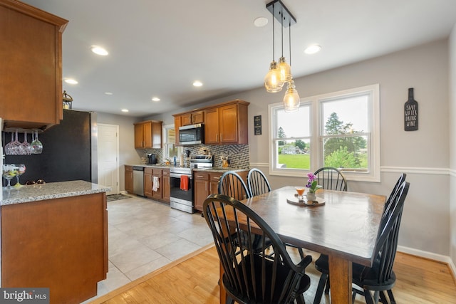 dining space featuring recessed lighting and light tile patterned flooring