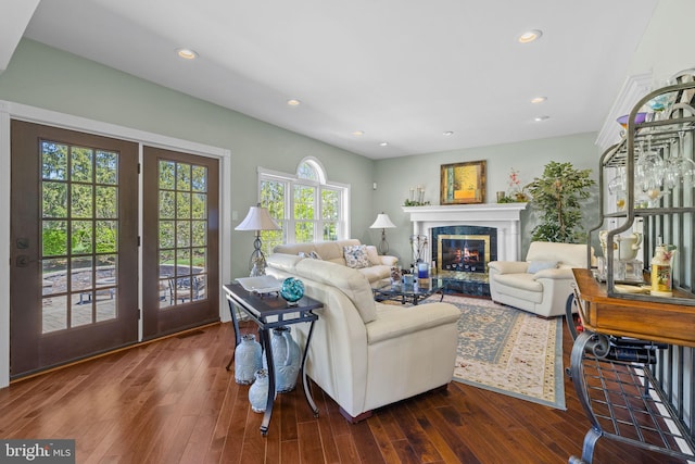 living area with a fireplace, recessed lighting, visible vents, and dark wood-type flooring
