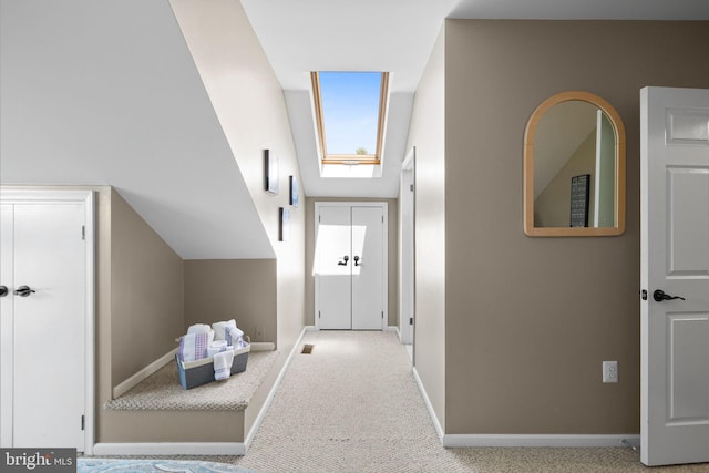hall with baseboards and carpet floors