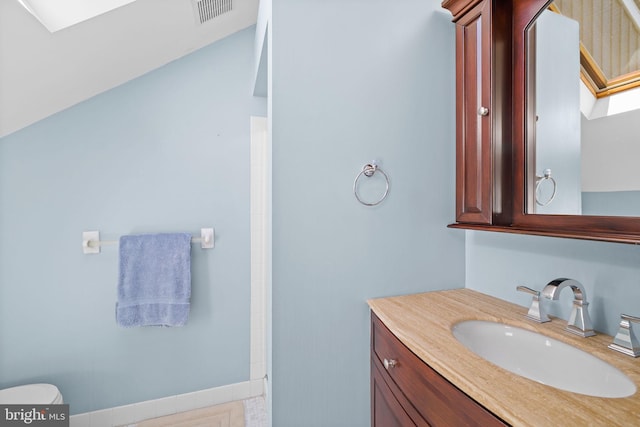 bathroom with visible vents, toilet, and vanity